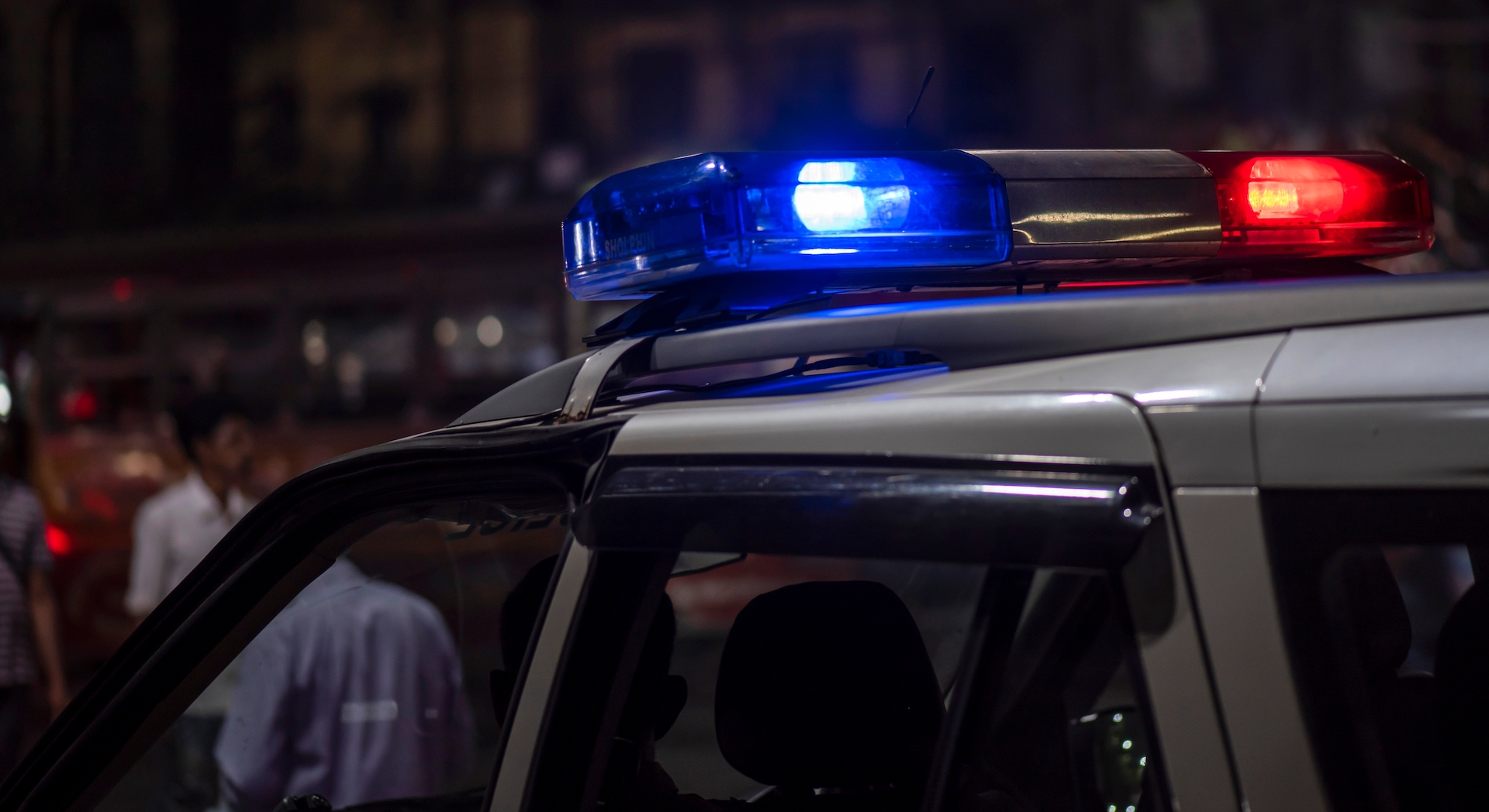 Emergency light of police patrolling car on street in night