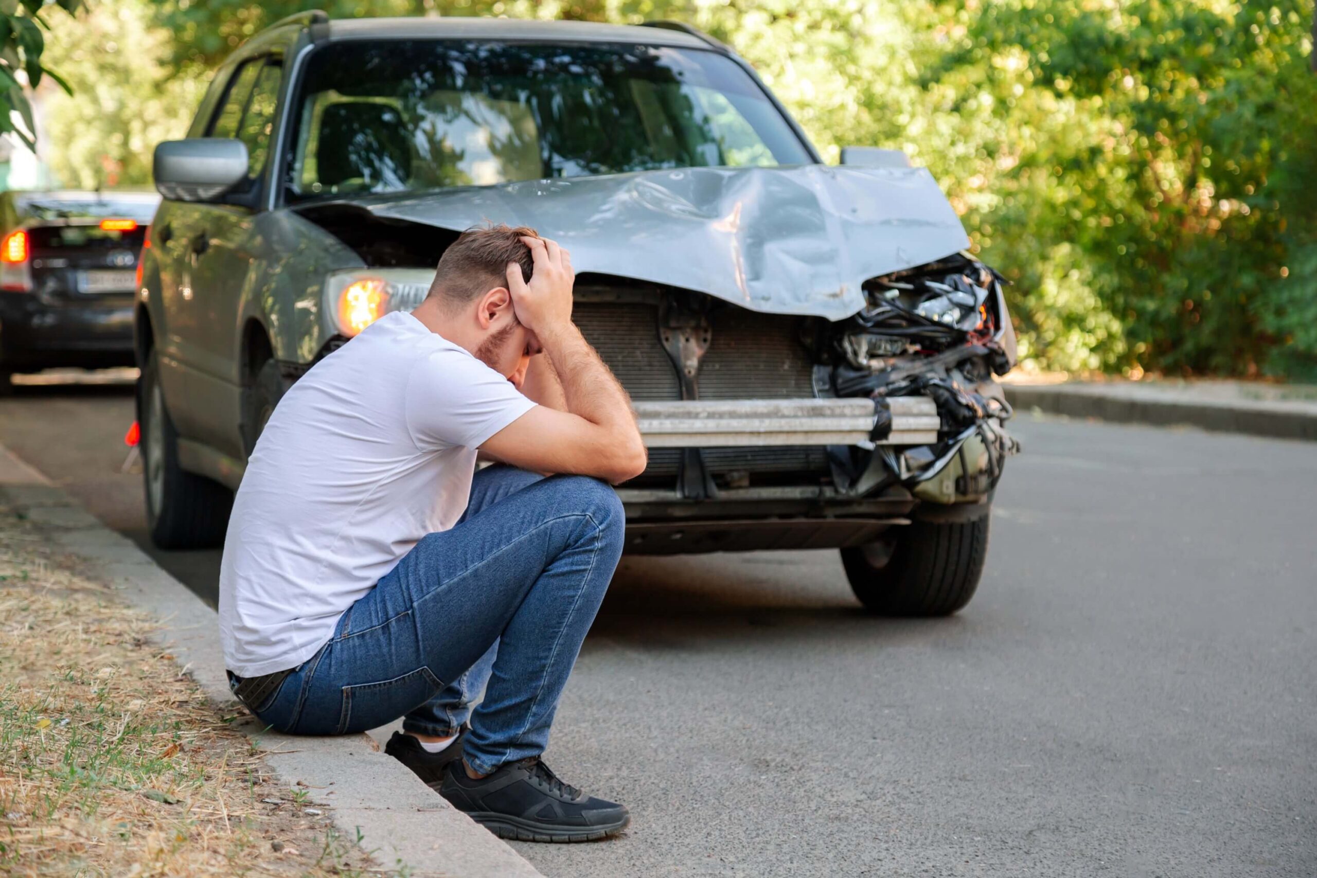 Man holding his head after a car accident